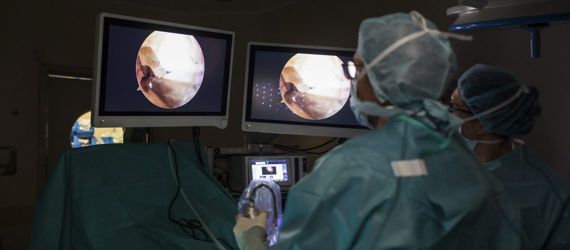 team of surgeons operating a foot with non-invasive methods in the operating room