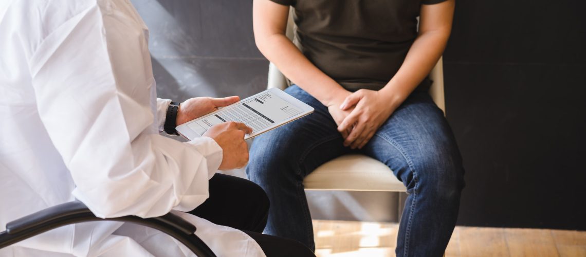 Male doctor and testicular cancer patient are discussing about testicular cancer test report. Testicular cancer and prostate cancer concept.