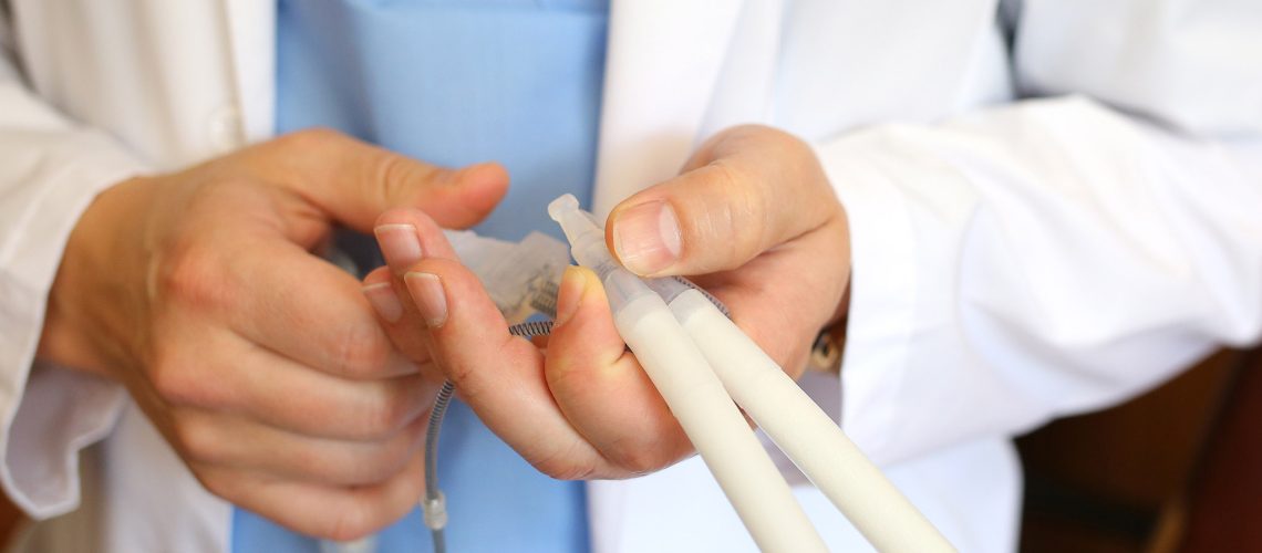 Doctor andrologist holding hydraulic penile prosthesis for falloprosthetics. Penile prosthesis. Urology and Andrology. Health male concept